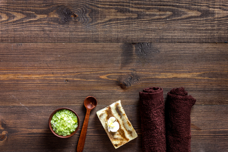 Relax concept. Handmade organic soap and bath salt on wooden table background top view.の写真素材
