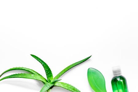 Homemade skin care. Aloe vera leafs, glass of aloe vera juice and soap on white background top view.の写真素材