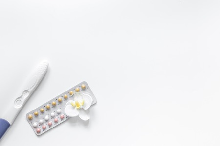 Pregnancy test and pills on white background top view.の写真素材