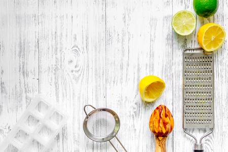 Preparing lemonade. Lemon, lime, grater on wooden background top view