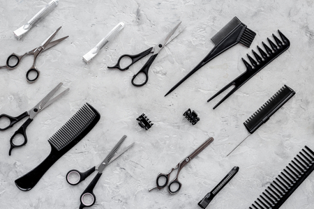 Pattern of combs and hairdresser tools on grey table background top view.の写真素材