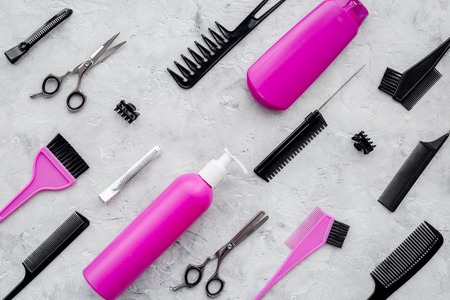 Pattern of combs and hairdresser tools on grey table background top view.の写真素材