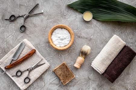Preparing for men shaving. Shaving brush and razor on grey stone table background top view.の写真素材