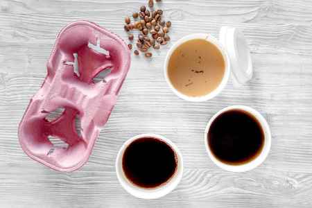 Coffee to go. Coffee cups on wooden table backound top view.の写真素材
