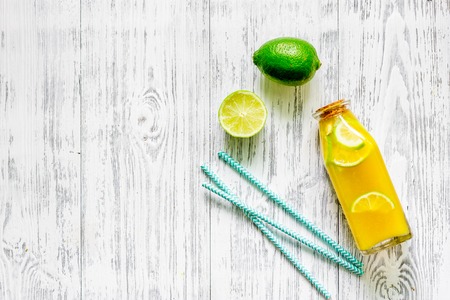 Bottle of fresh lemonade and fruits on grey table background top view.の写真素材
