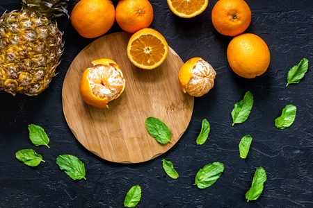 Citrus concept. Fresh oranges on black table background top view.の写真素材