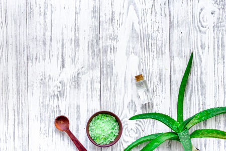 Skin care. Aloe vera leafs and spa salt on wooden background top view copyspaceの写真素材
