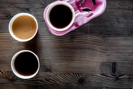 Coffee take away. Coffee cups with covers on wooden table backound top view.の写真素材