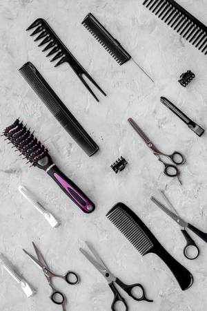 Pattern of combs and hairdresser tools on grey table background top viewの写真素材