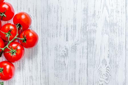 Prepring for cooking dinner. Tomato on wooden table background top view copyspaceの写真素材