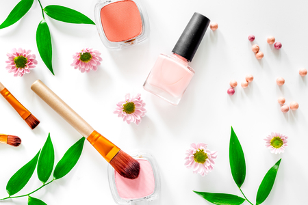 Cosmetics. Eyeshadow, blush, brushes and nail polish on white table background top view.の写真素材