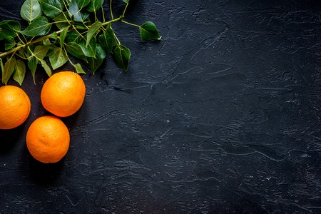Citrus concept. Fresh oranges on black table background top view.の写真素材