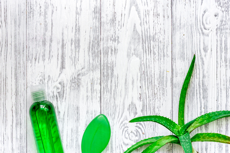 Homemade skin care. Aloe vera leafs, glass of aloe vera juice and soap on wooden table background top view.の写真素材