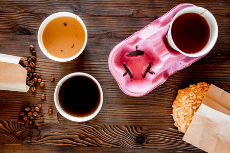 Coffee take out. Coffee cups with covers, coffee beans and cookies on wooden table backound top view.の写真素材
