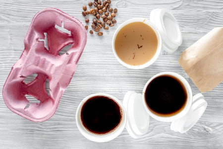 Coffee to go. Coffee cups on wooden table backound top view.の写真素材