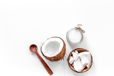 Body treatment. Coconut cosmetics on white background top view copyspace.