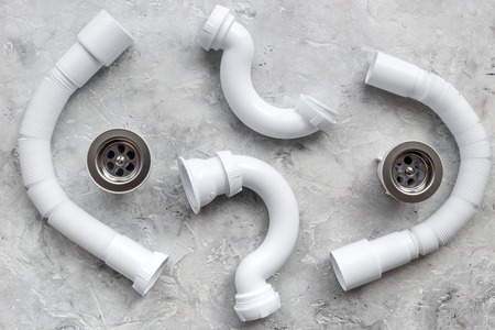 Clear clogged sink drains. Parts on grey stone background top view.の写真素材