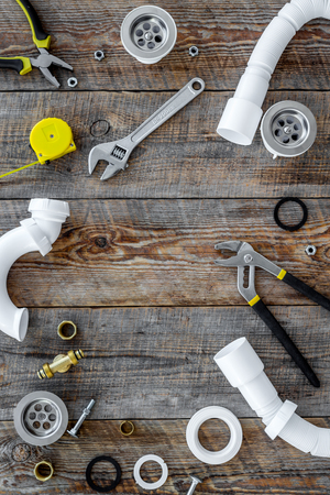 Plumber tools on wooden background top view.の写真素材