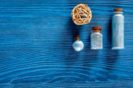 Spa set with sea salt, blue clay and lotion on blue wooden table background top view copyspaceの写真素材