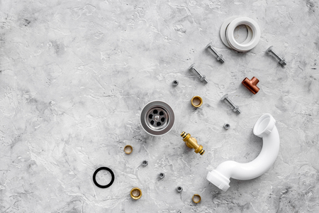 Sink drain parts and plumbing tools pattern on grey stone background top view copyspaceの写真素材