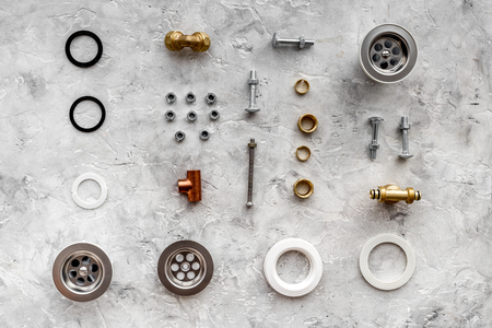 Sink drain parts and plumbing tools pattern on grey stone background top viewの写真素材