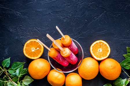 Fresh fruits on black table background top view.の写真素材