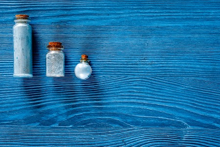 Spa set with sea salt, blue clay and lotion on blue wooden table background top view.の写真素材