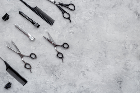 Hairdresser workplace. Combs and sciccors on grey table background top view copyspaceの写真素材