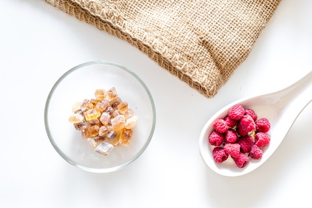 Making summer preserve. Raspberry and sugar on white background top viewの写真素材