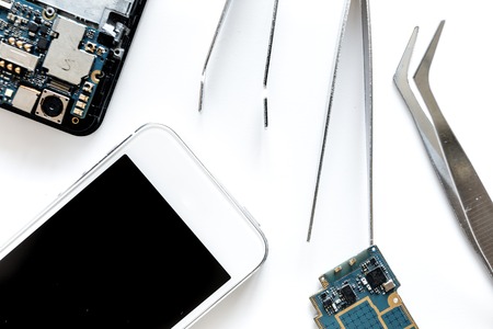 Repairing gadgets. Parts and tools on white background top viewの写真素材