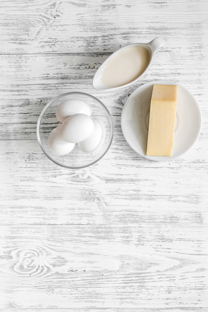 Milk, cheese, eggs on light wooden background top view copy spaceの写真素材