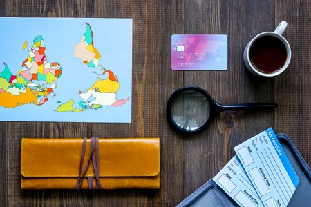 Preparing for trip. World map, bank card and tickets on wooden table background top viewの写真素材