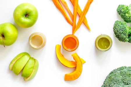 Preparing baby food. Broccoli, pumpkin, apple puree on white background top viewの写真素材