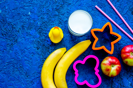 Fuit snack for clildren. Fruits and milk on blue table background top view.の写真素材