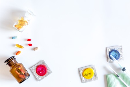 Visit the urologist. Tools and condoms on white background top view.の写真素材