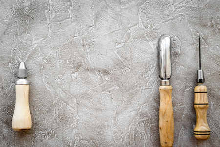 Leather craft tools on grey stone background top view copyspaceの写真素材