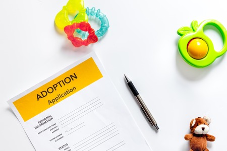 Adoption application near paper silhouette of family and toys on white background top view copyspaceの写真素材