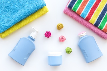 Bath accessories. Towels, soap, shampoo, lotion, cream on white background top viewの写真素材