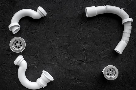 Disassembled sink drain pipe on black background top view copyspaceの写真素材