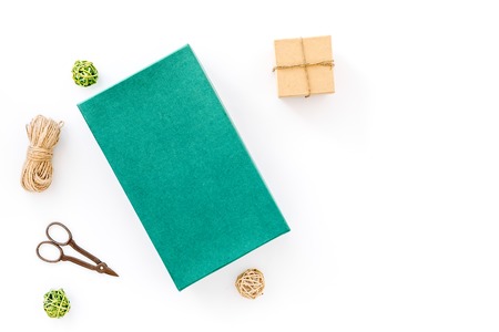 To wrap gift. Box, colored paper, thin cord, sciccors on white background top view copyspace mockupの写真素材