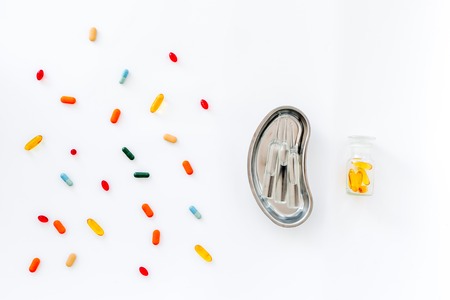 Medicine concept. Colored pills and cuvette with ampoulie on white background top viewの写真素材