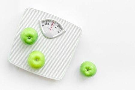 Bathroom scale and apples on white background top view copyspaceの写真素材