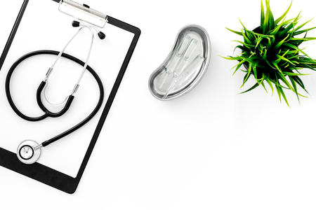Doctor's table. Clip pad, stethoscope and cuvette with ampoulie on white background top view.の写真素材
