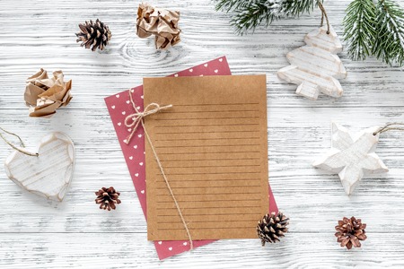 Plan for the year. Sheet of paper, cup of coffee and christmas decoration on grey wooden background...