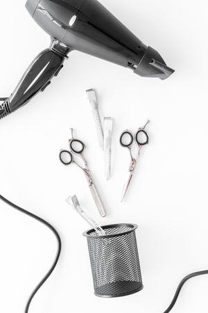styling hair with scissors, dryer and hairdresser tools in barbershop on white background top viewの写真素材