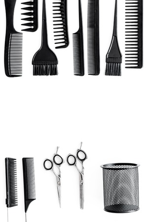 hairdresser working desk space with tools for hair styling on white desk background top view mock upの写真素材