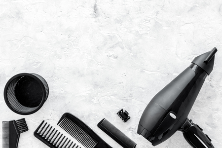 hairdresser working desk space with dryer and tools for hair styling on gray stone desk background top view mock upの写真素材