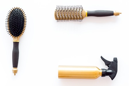 combs and hairdresser tools for styling on white work desk background top view mockupの写真素材