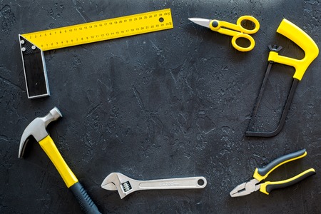 set of tools for build and repair house on dark desk background top view frame mock-up