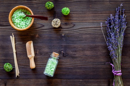 bath salt in herbal cosmetic set with lavender on wooden desk background top view space for textの写真素材